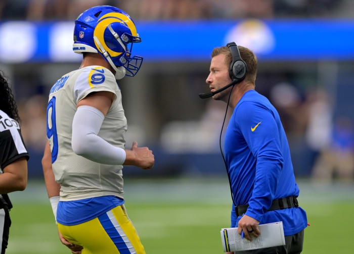 Los Angeles Rams quarterback Matthew Stafford and coach Sean McVay talk on the sidelines during a game.